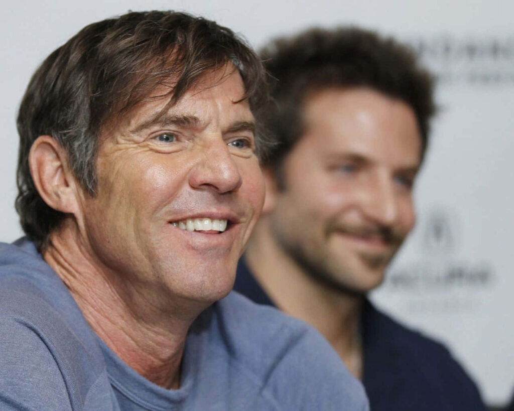 Dennis Quaid smiling in sharp focus with blurred Bradley Cooper in soft neutral background wallpaper