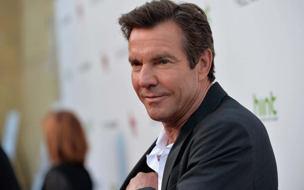 Dennis Quaid in sharp suit at event with blurred background confident expression wallpaper