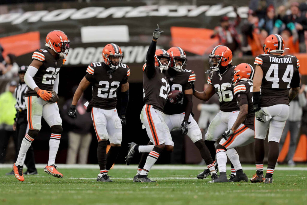 Denzel Ward and Cleveland Browns defense celebrate key NFL play against Detroit Lions packed stadium Wallpaper