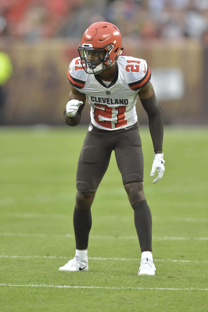 Denzel Ward Cleveland Browns in brown white uniform ready to make a play NFL action wallpaper
