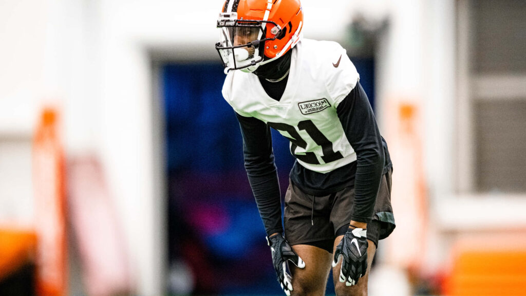 Denzel Ward Cleveland Browns intense off-season workout focused athletic stance indoor lighting Wallpaper