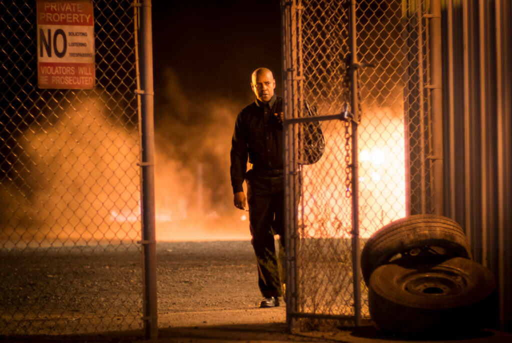 Denzel Washington at metal gate with dramatic lighting smoky cinematic background wallpaper