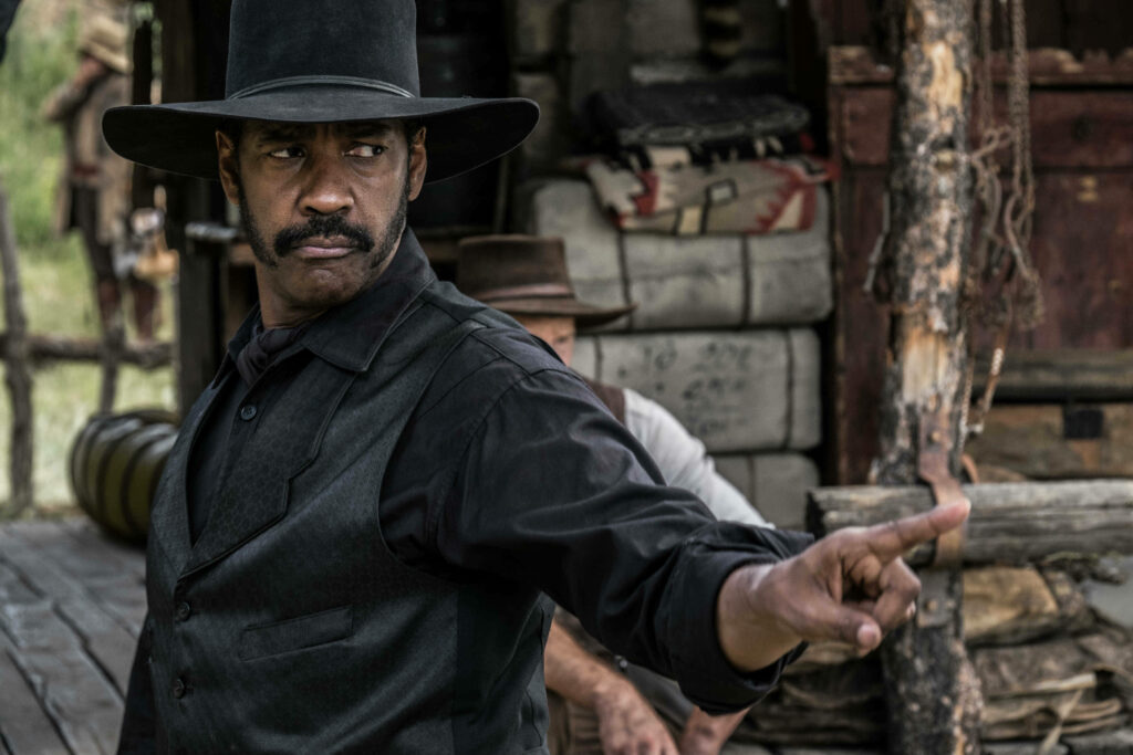 Denzel Washington cowboy in classic Western setting pointing with intense focused expression wallpaper