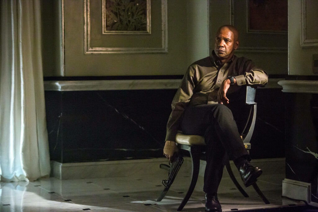 Denzel Washington intense scene with weapon in dim room from Equalizer movie final moments wallpaper