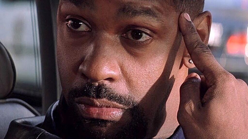 Close-up of Denzel Washington intense Training Day role commanding presence behind the wheel wallpaper