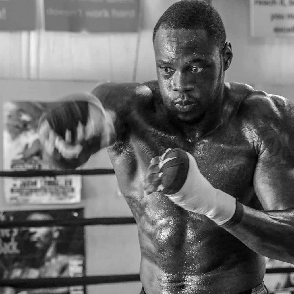 Deontay Wilder intense boxing training black and white wallpaper showing power and focus