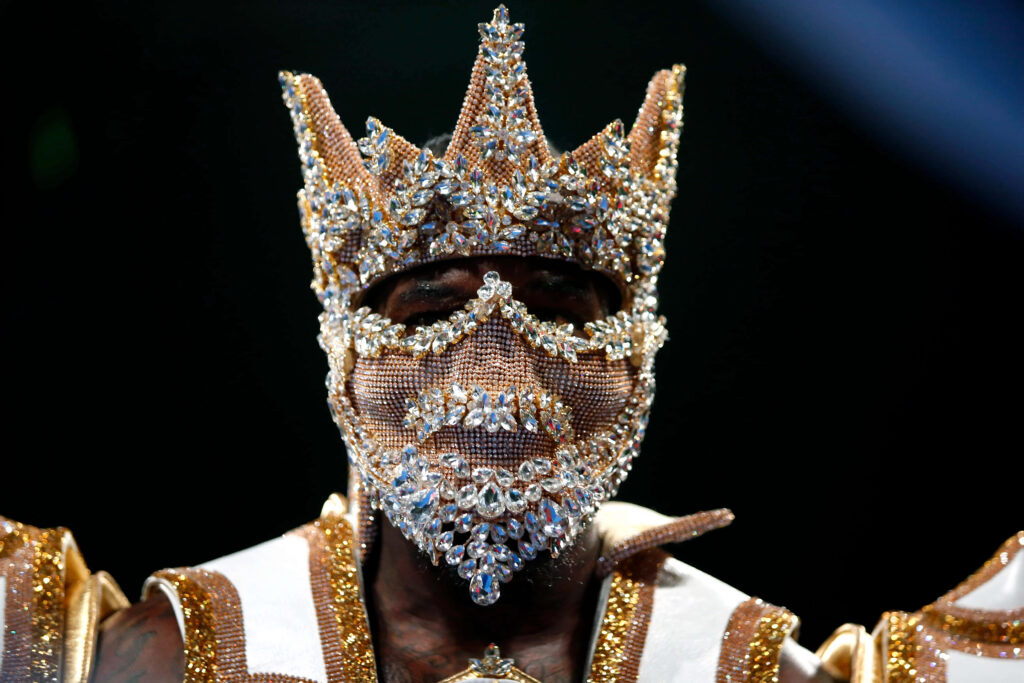 Deontay Wilder in jeweled mask and crystal crown exuding regal power and intense presence wallpaper
