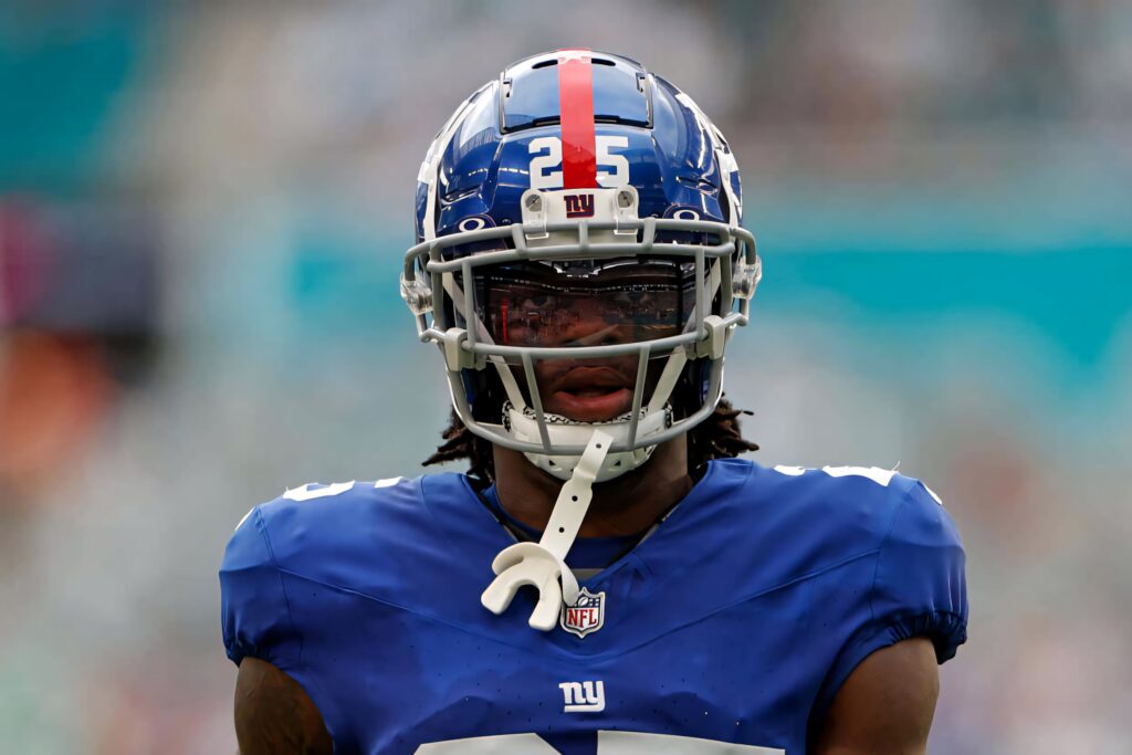 Deonte Banks in blue football uniform helmet visor intense focus professional player wallpaper