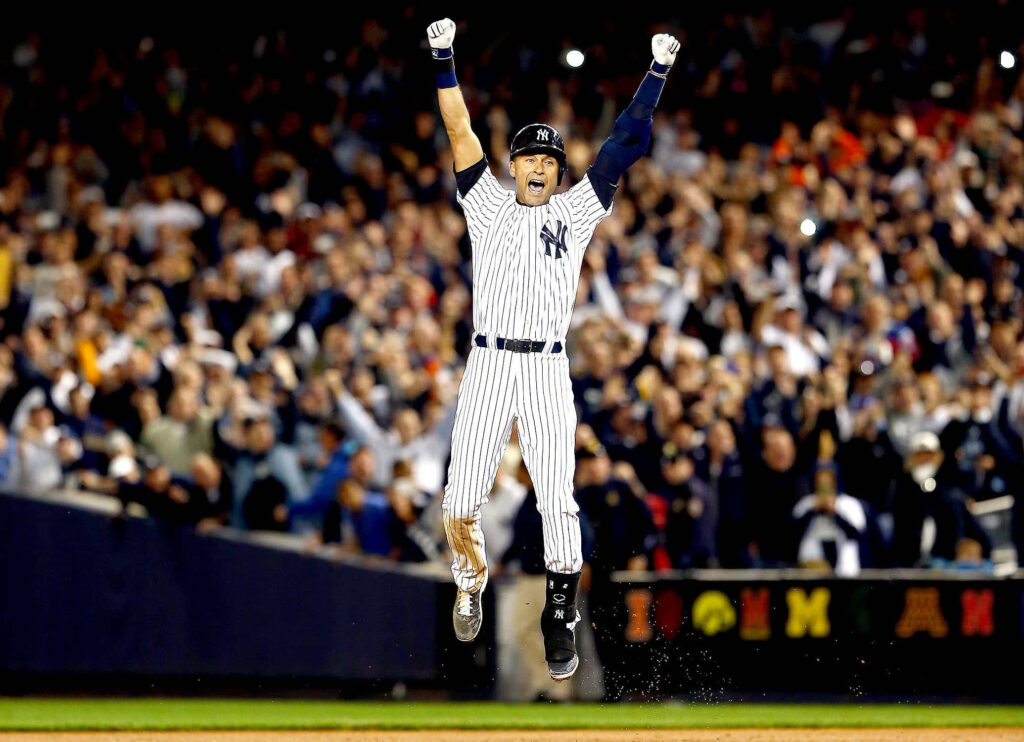 Derek Jeter leaps celebrating in New York Yankees pinstripes with vibrant crowd background Wallpaper