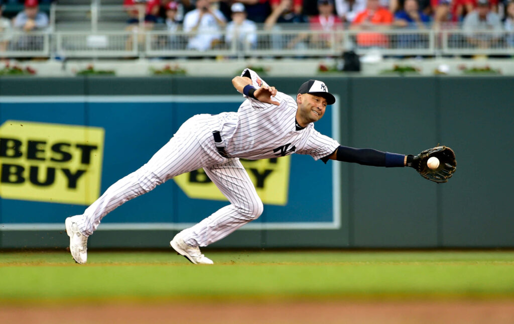Derek Jeter diving catch in Yankees pinstripes vibrant stadium baseball wallpaper background
