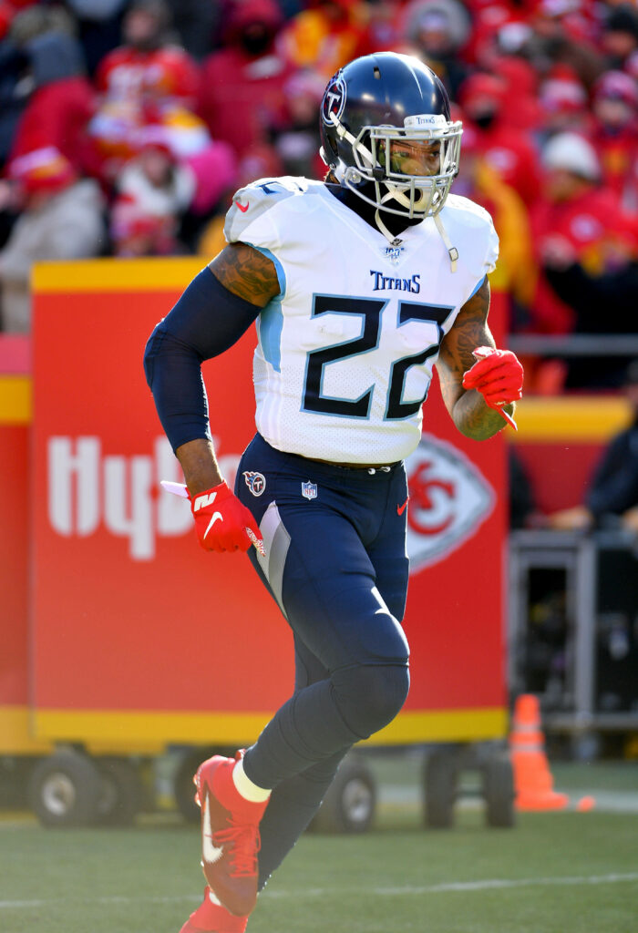 Derrick Henry running in Tennessee Titans navy uniform vibrant NFL stadium game day wallpaper background