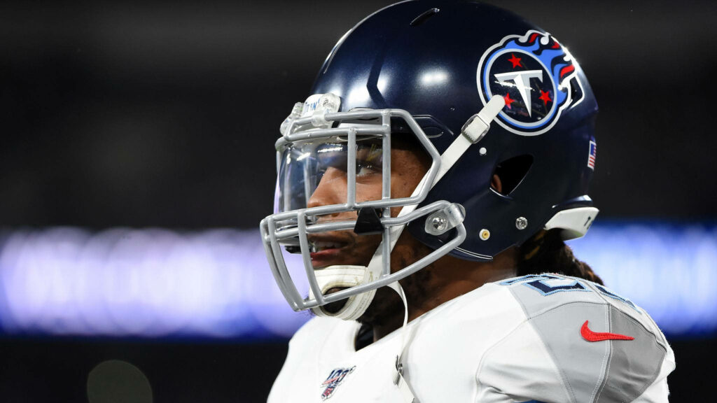 Close-up of Derrick Henry Tennessee Titans in full uniform under stadium lights intense focus Wallpaper