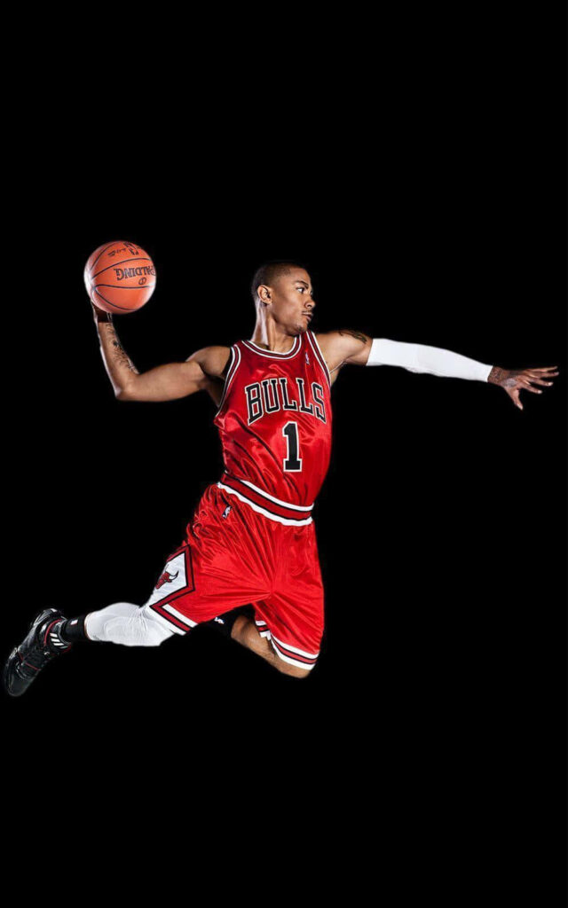 Derrick Rose Chicago Bulls #1 mid-air dunk intense focus black background NBA wallpaper