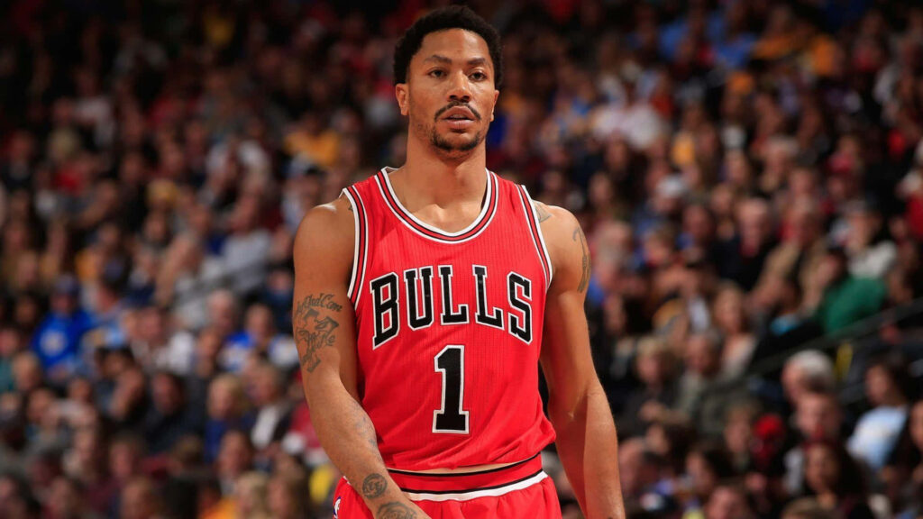 Derrick Rose in red Chicago Bulls jersey on court with vibrant fan background showcasing leadership Wallpaper