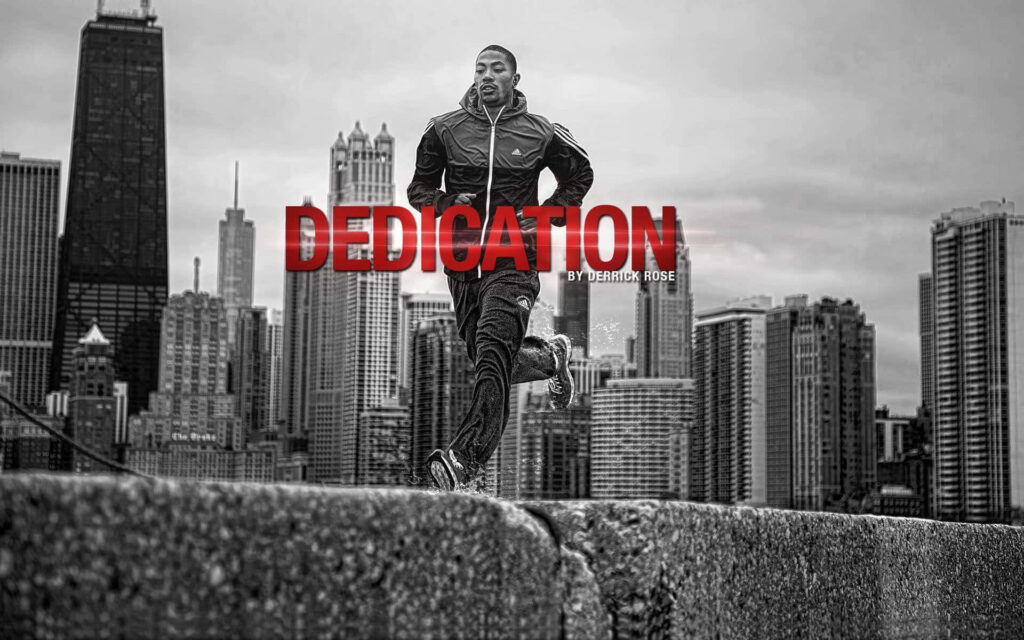 Derrick Rose running intensely with urban skyline background bold red text basketball wallpaper