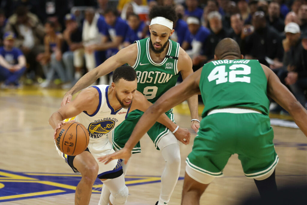 Derrick White defending Stephen Curry in intense NBA Celtics vs Warriors game action wallpaper