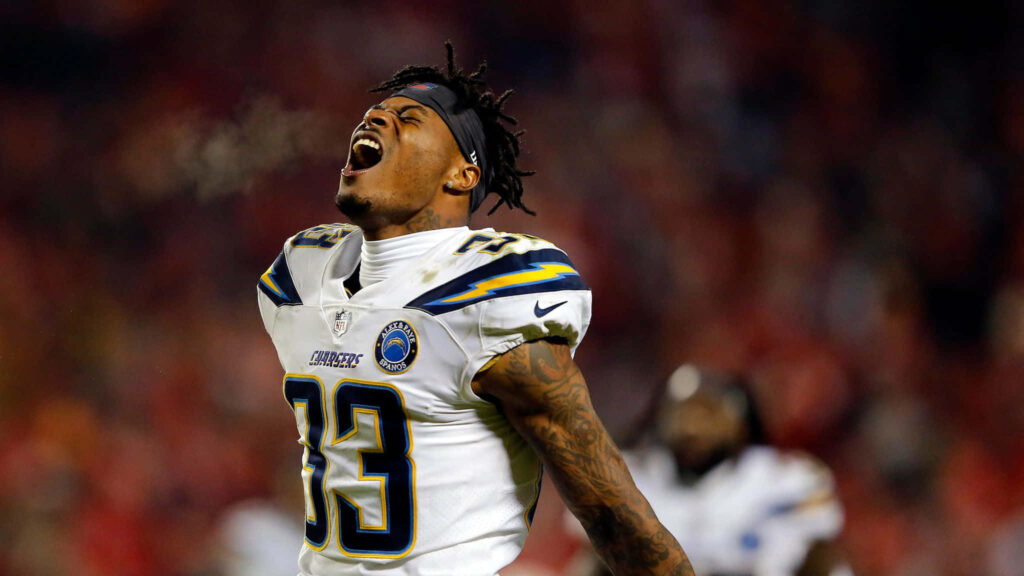 Derwin James Jr in Chargers white blue uniform roaring under stadium lights NFL wallpaper background
