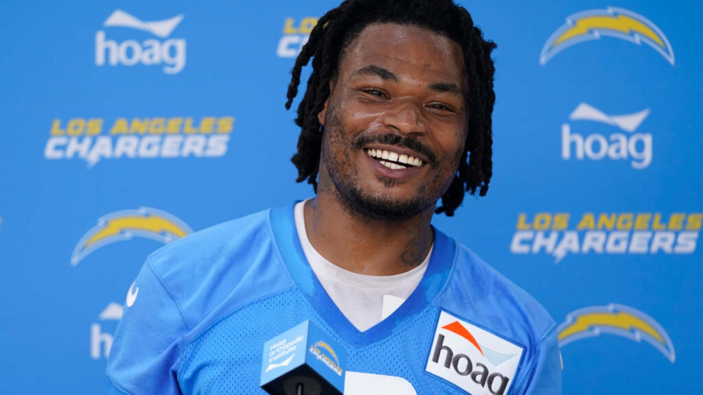 Derwin James Jr smiling in Los Angeles Chargers jersey interview with blue team backdrop wallpaper