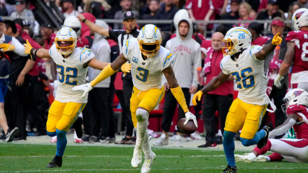 Derwin James Jr touchdown celebration with powder blue gold white team colors in stadium wallpaper