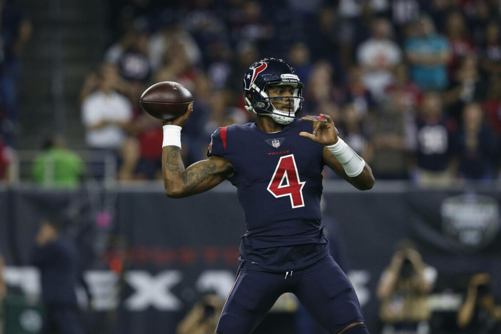 Deshaun Watson Houston Texans preparing to throw pass versus Dolphins vibrant stadium background Wallpaper