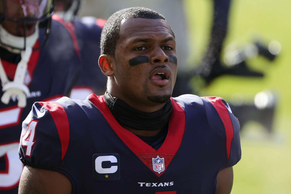 Deshaun Watson Houston Texans surprised expression red navy uniform blurred stadium background Wallpaper