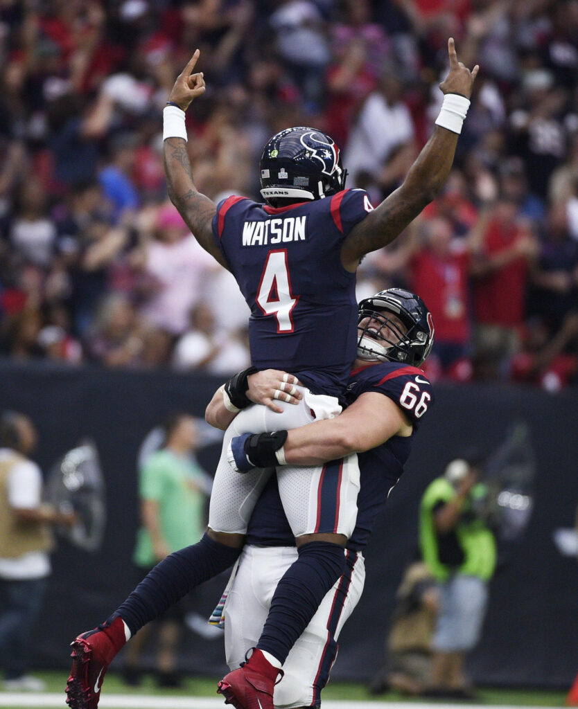 Deshaun Watson and Nick Martin in Houston Texans uniforms celebrating victory on football field Wallpaper