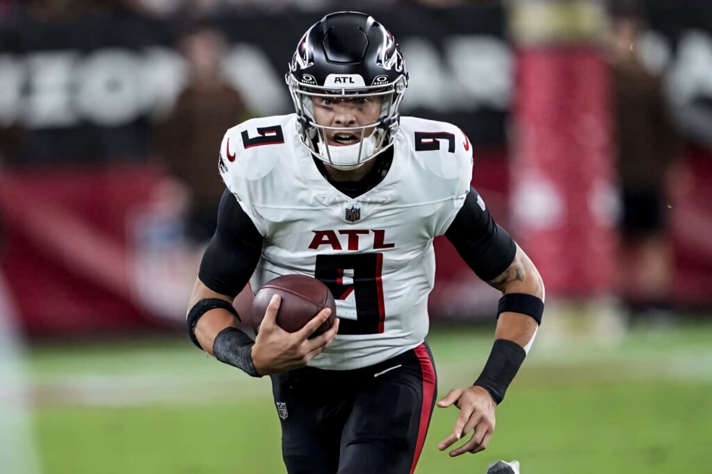Desmond Ridder Atlanta Falcons quarterback in white black uniform mid-action vibrant stadium wallpaper