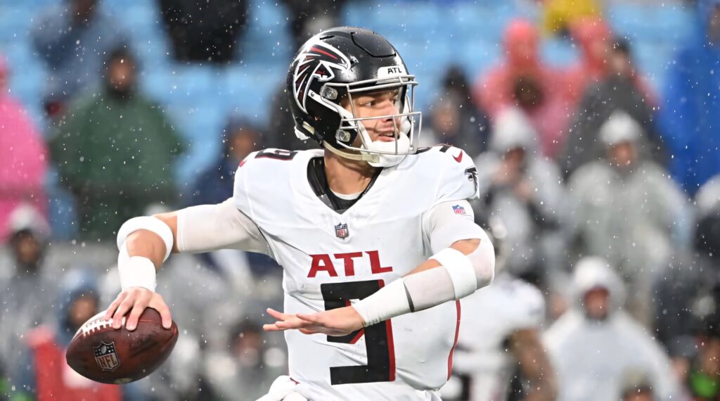 Desmond Ridder Atlanta Falcons quarterback focused throwing football in rainy NFL game wallpaper