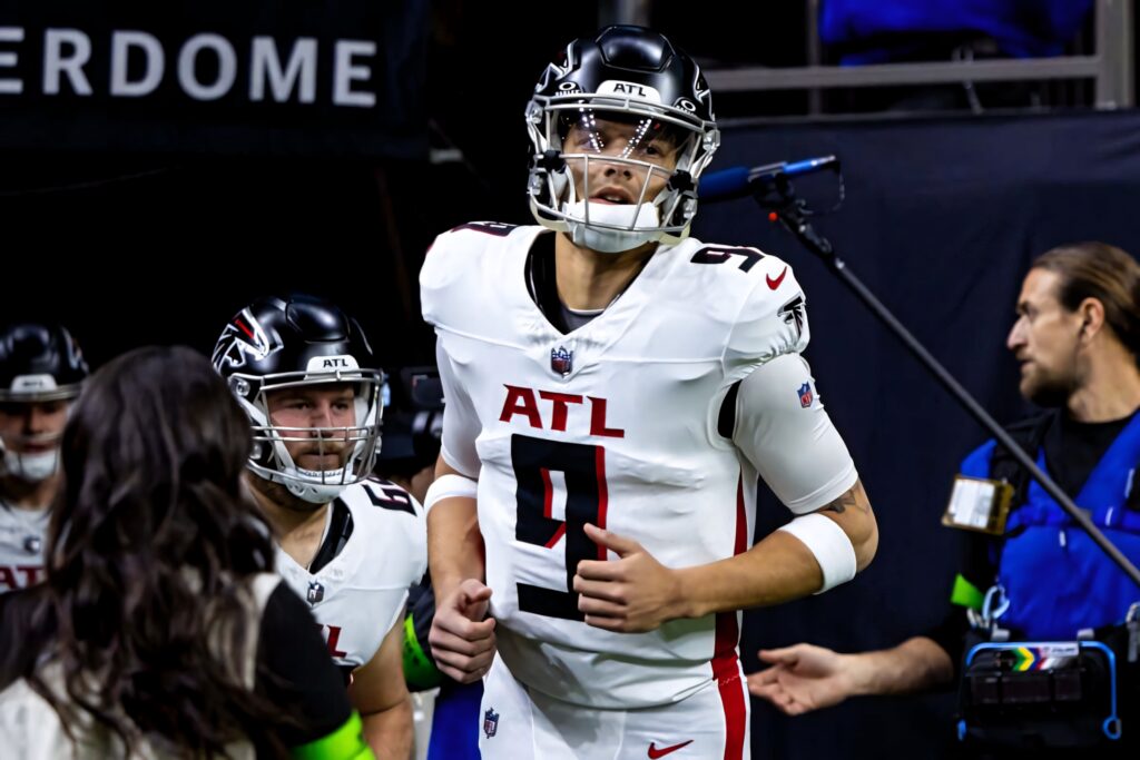 Desmond Ridder Atlanta Falcons quarterback in white red jersey ready to play under stadium lights Wallpaper