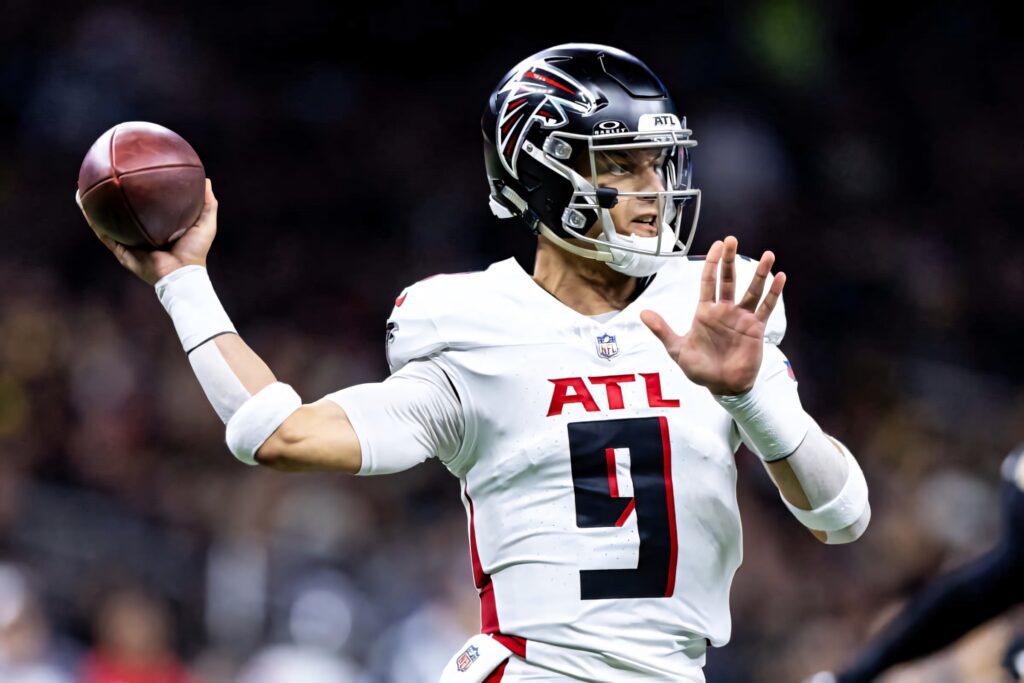 Desmond Ridder Atlanta Falcons quarterback throwing football in white uniform stadium background Wallpaper