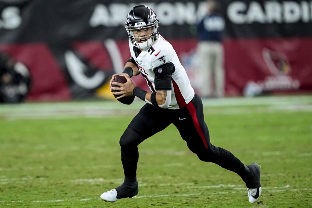 Desmond Ridder Atlanta Falcons quarterback in action poised to throw under bright stadium lights Wallpaper
