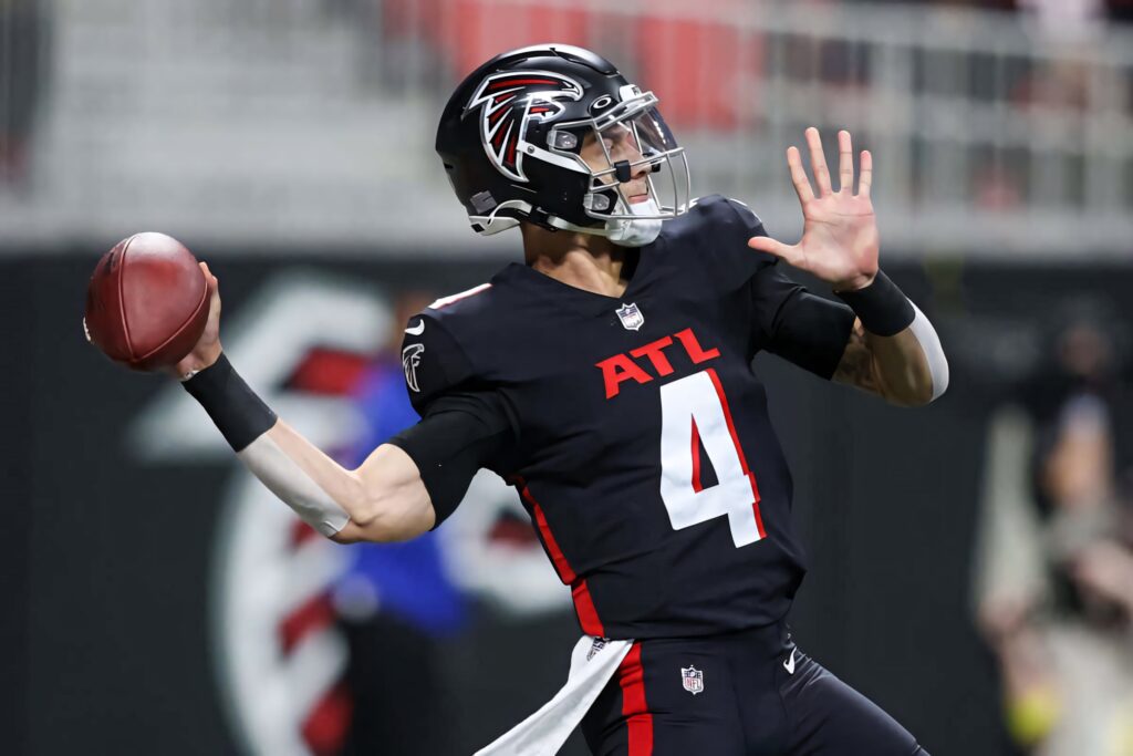 Desmond Ridder Atlanta Falcons quarterback throwing football in black red white uniform stadium wallpaper