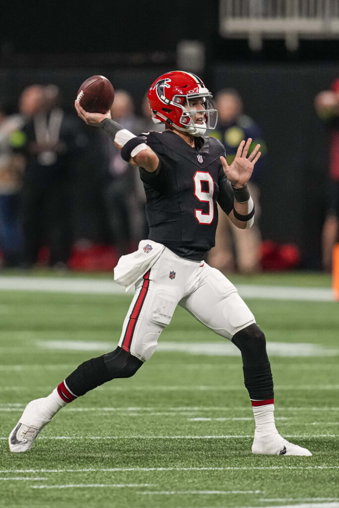 Desmond Ridder Atlanta Falcons quarterback throwing football mid-action vibrant stadium background Wallpaper