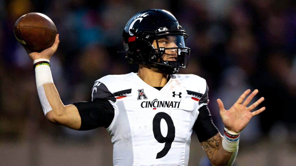 Desmond Ridder Cincinnati Bearcats quarterback mid-throw in dynamic football action wallpaper