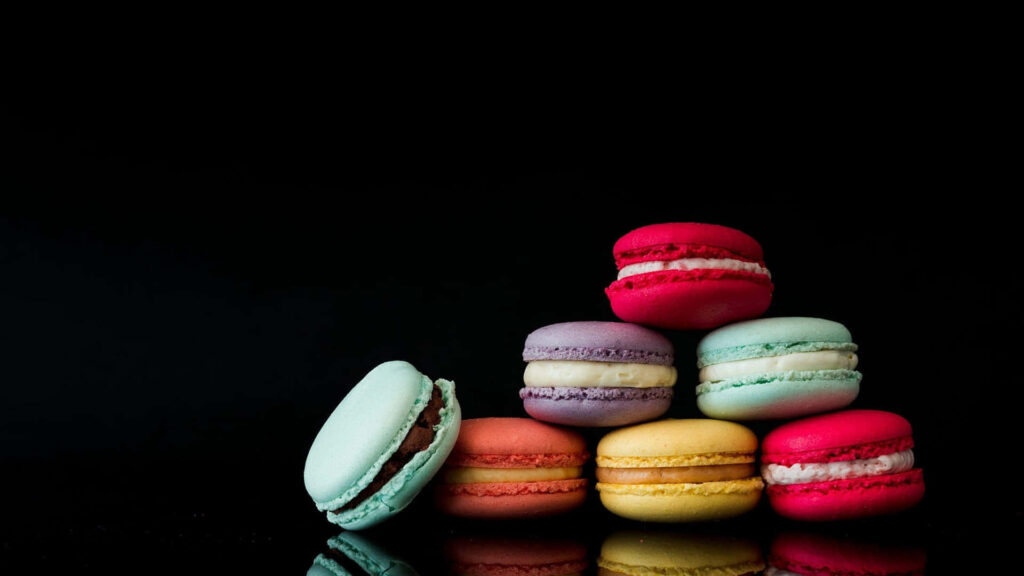 Tempting Macaron Delights in an Artistic Dessert Display Wallpaper