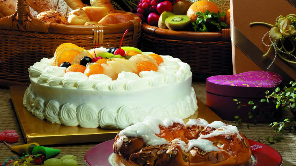 Desserts and Bakery Delights Amidst the Bounties of Fruits and Breads Wallpaper