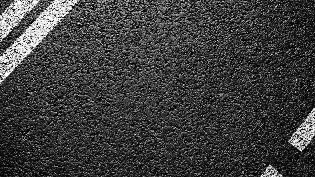 Rugged Black Asphalt Road Texture with White Lines - Wallpaper