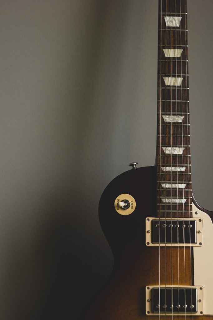 Intricate Electric Guitar Fretboard Wallpaper: Minimalist Design