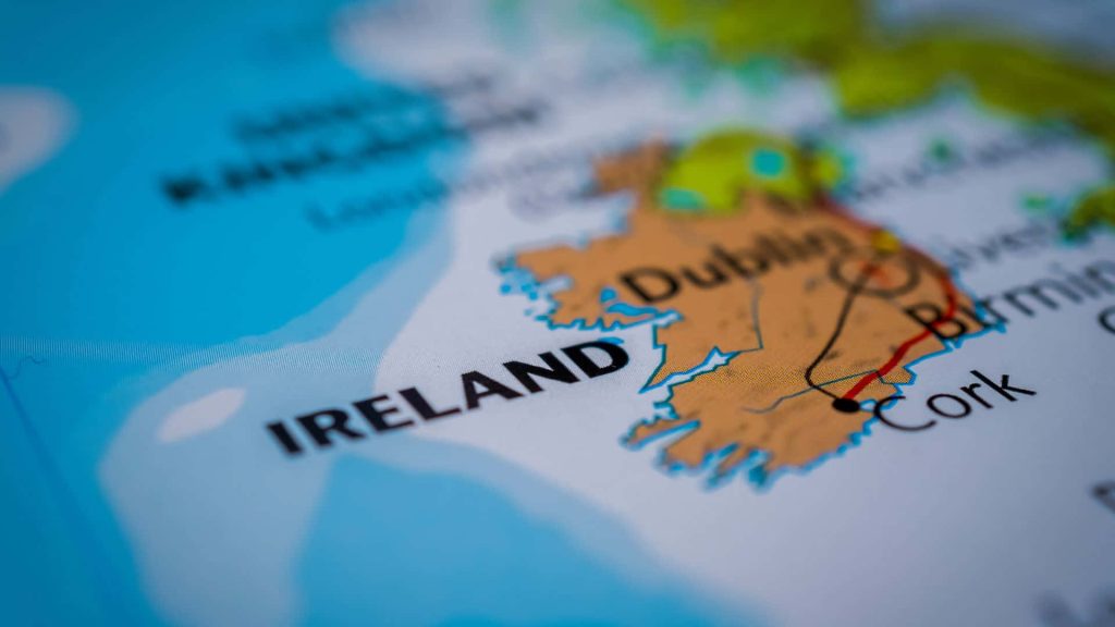 Detailed Ireland map wallpaper showing Dublin and Cork with tan land and blue ocean background