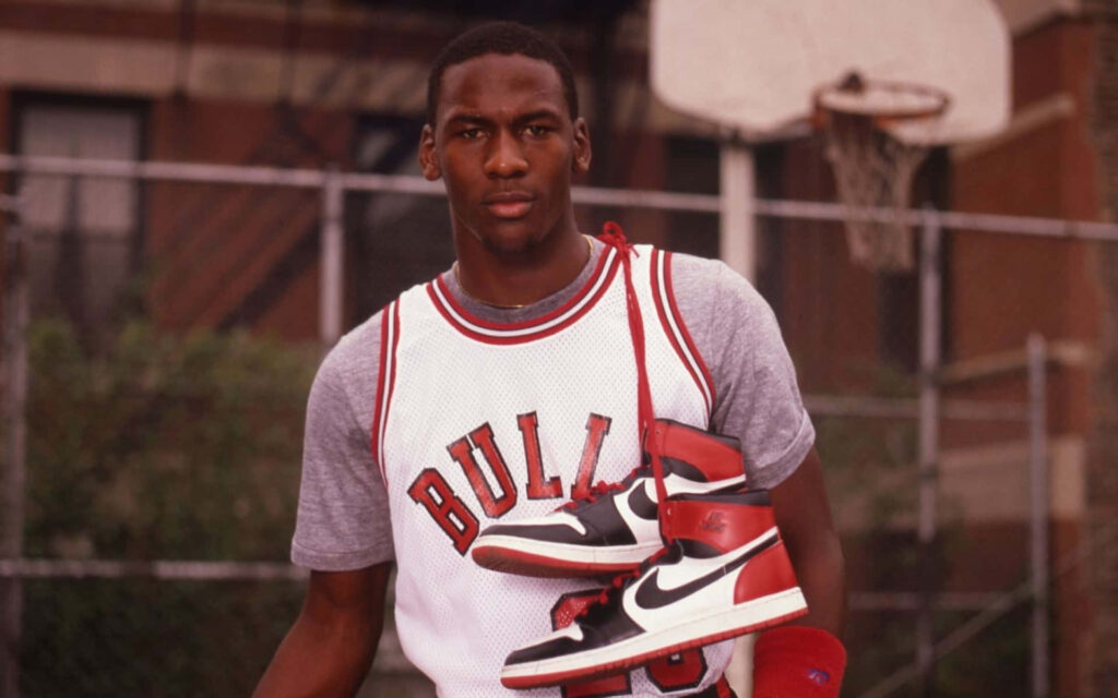 Michael Jordan donning his legendary Chicago Bulls #23 jersey, radiating sheer determination Wallpaper