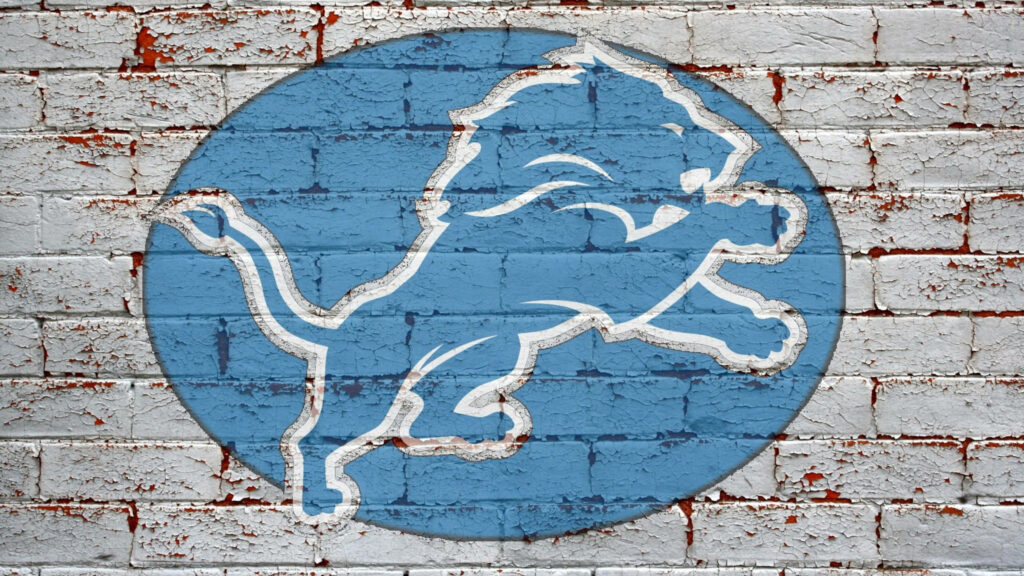 Detroit Lions blue logo on weathered white brick wall urban texture team spirit wallpaper