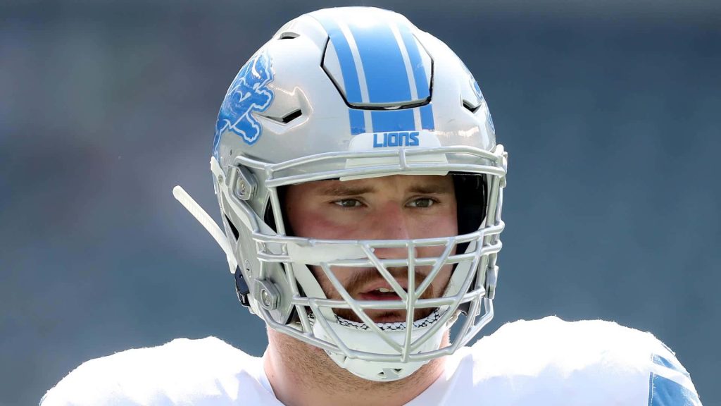 Close-up high-res portrait of Detroit Lions center Frank Ragnow in authentic NFL helmet Wallpaper