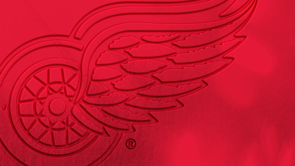 Detroit Red Wings logo embossed on vivid red background hockey team wallpaper display
