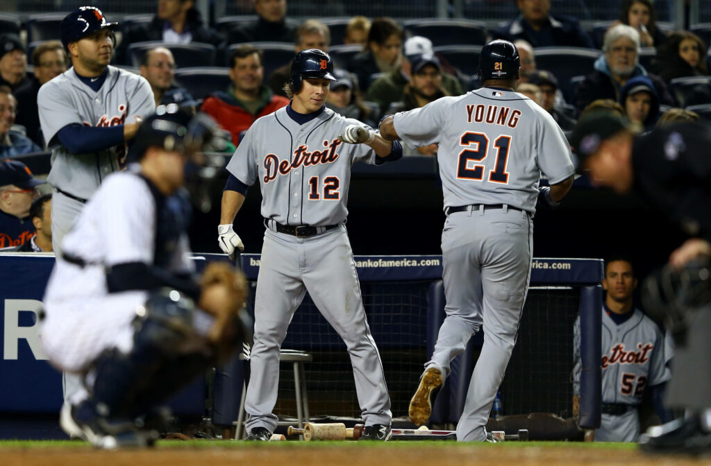 Detroit Tigers players Casey Mize and Dmitri Young in grey uniforms team up during intense game Wallpaper