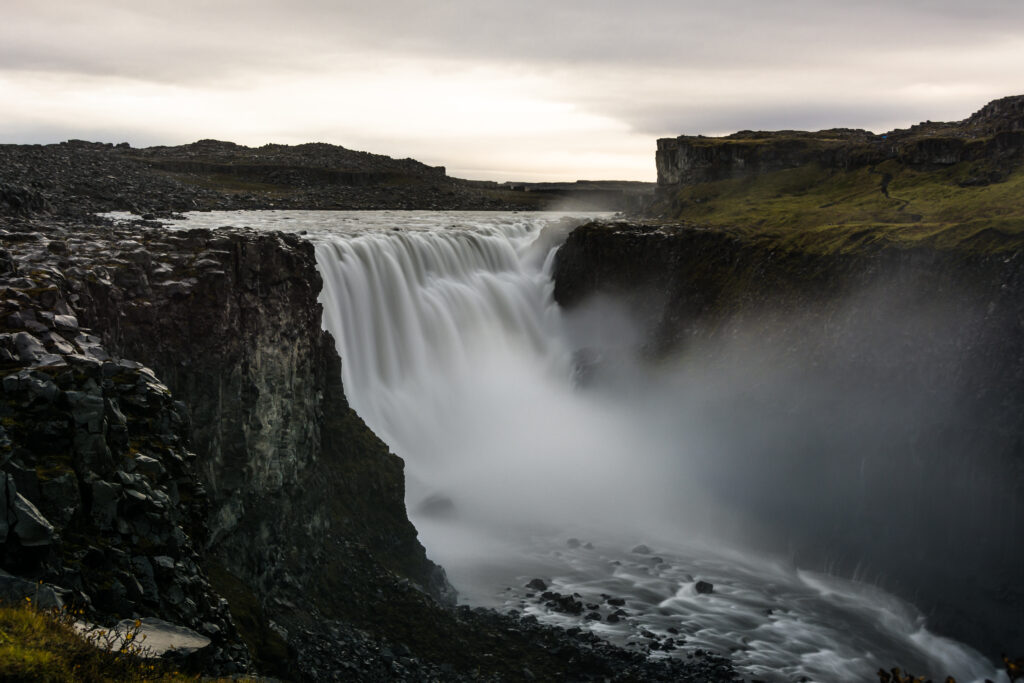 Dettifoss waterfall in Iceland cascading amid rugged cliffs and misty wild natural landscape wallpaper