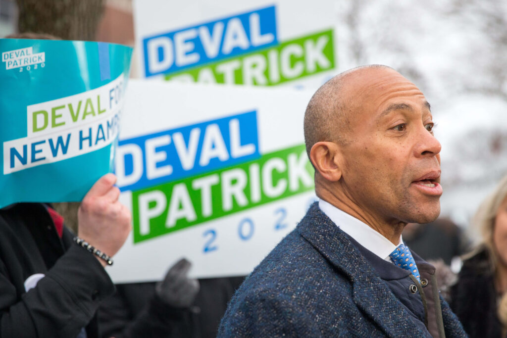 Deval Patrick 2020 campaign rally with supporters holding blue green white signs winter background Wallpaper