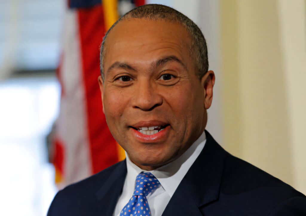 Deval Patrick smiling headshot with American flag background natural light wallpaper image