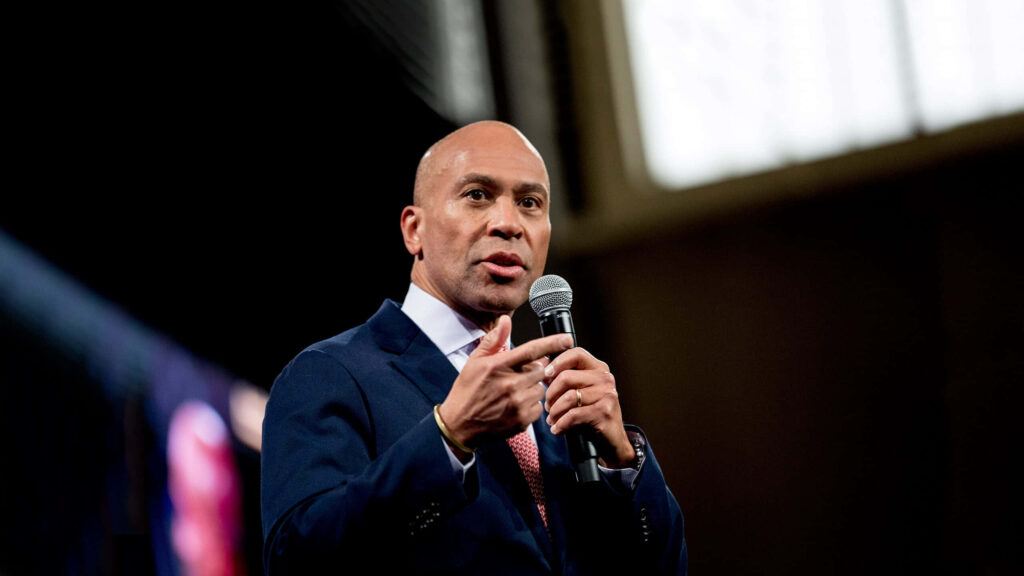 Deval Patrick speaking passionately in a sharp suit with dramatic lighting emphasizing leadership Wallpaper