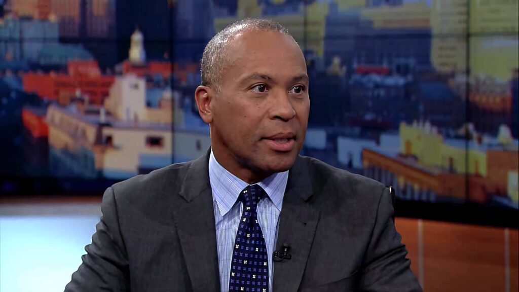 Deval Patrick in sharp gray suit and blue tie during city studio interview with blurred background Wallpaper