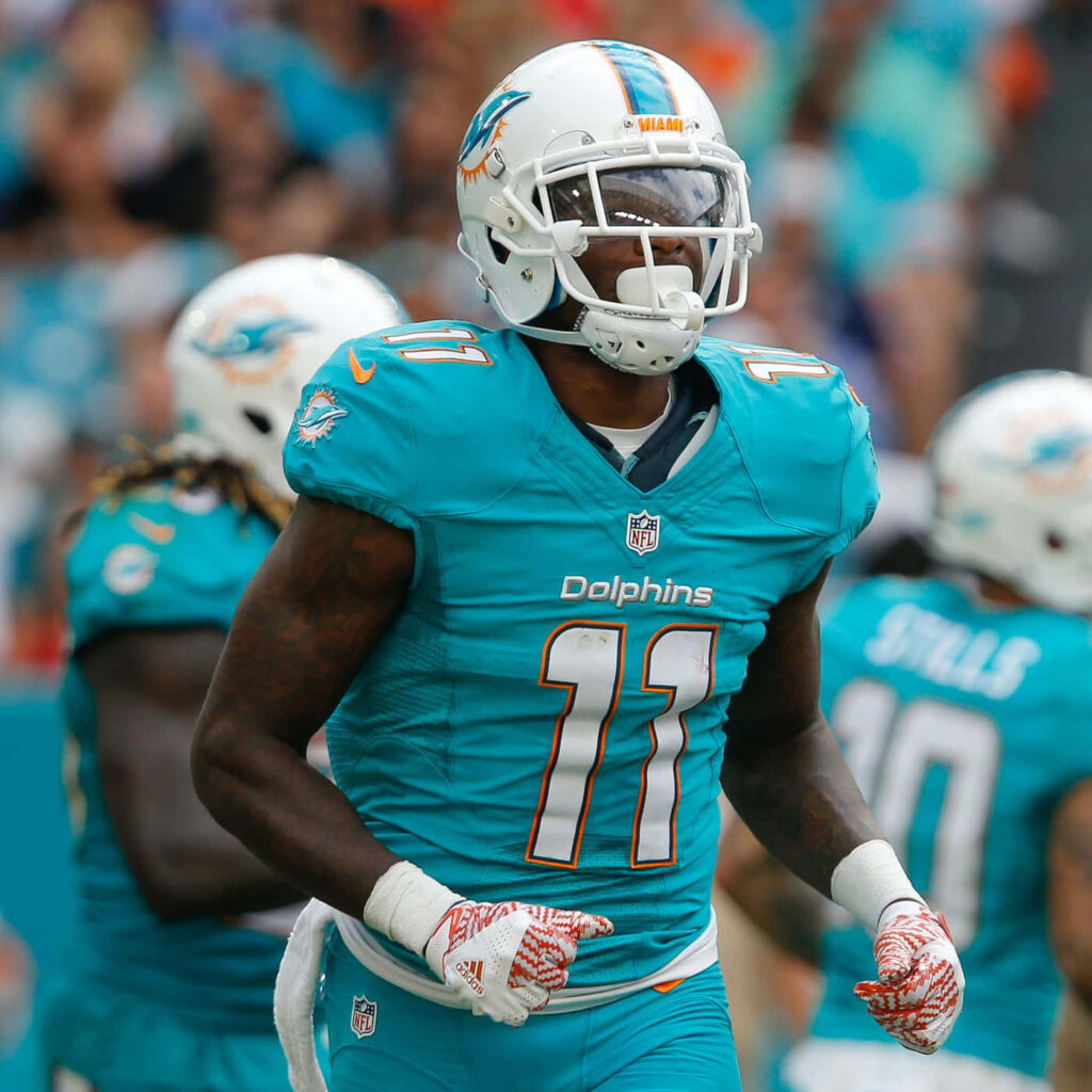 Devante Parker Miami Dolphins number 11 in teal uniform catching a football on game day wallpaper